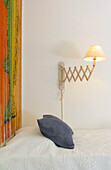 Bed with wooden curtain and concertina lamp