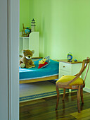Child's room with soft toy on single bed