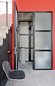 Staircase with treads and risers made of pre cast concrete tiles and built-in closet with panelled doors