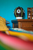 Stained glass night lamp on chest of drawers in turquoise bedroom