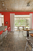 Red open plan kitchen with barstools