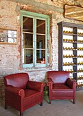 Armchairs by window in house, Carmelo, Uruguay