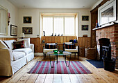 Exposed brickwork fireplace in sunlit 1820s English living room