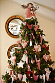Heart and star shaped handmade Christmas decorations on tree