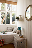 Single bed under sunlit window of Edwardian school house conversion