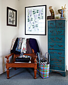 Tall boy and blouses on wooden armchair with artwork Masterton New Zealand