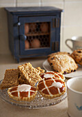 Flapjacks and bakewell tarts on plate in country kitchen