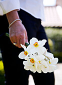 Woman holds a bunch of daffodils