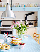 1950s kitchen with stainless steel pendant lights and summer fruit cake