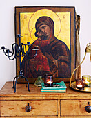 Religious artwork on wooden set of drawers in London home