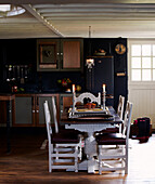 Lit candles on dining table in cottage kitchen