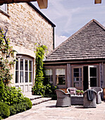 Wicker table and chairs in farmhouse courtyard exterior