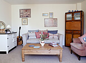 Low wooden coffee table in living room with guitar next to sofa