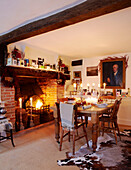 Lit candles in dining room of beamed country home