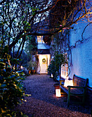 Garden lights on bench on gravel exterior of country home