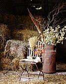 Dried flowers and metal chair in hay barn Essex England UK