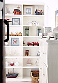 View through doorway to shelf storage in child's room in Forest Row farmhouse Surry England UK