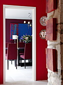 View through doorway to dining room in renovated Cotswolds mill house England UK