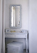 Light grey dressing table and mirror in bedroom alcove of family home London UK