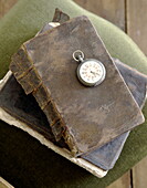 Vintage pocket watch on old leather book in Abbekerk home in the Dutch province of North Holland municipality of Medemblik