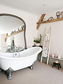 Large mirror with clawfoot bath in Oxfordshire farmhouse, England, UK