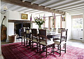 Dining table and double bass in beamed Oxfordshire farmhouse, England, UK