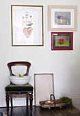 Bowl and trug with artwork and green velvet chair in Oxfordshire home, England, UK