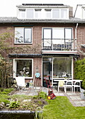 Lawn mower in back garden of semi-detached house with attic conversion in Bussum, Near Amsterdam, Netherlands