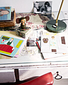 Cut out book with mouse figurine and family photo on desk in contemporary apartment, Amsterdam, Netherlands