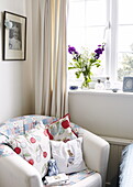 Armchair at window in childs room, Oxfordshire, England, UK