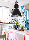 Black pendant lamp above table in kitchen of Mattenbiesstraat family home, Netherlands