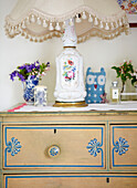 China lamp on upcycled chest of drawers in Oxfordshire farmhouse bedroom England UK