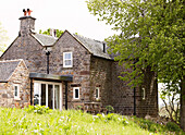 Stone farmhouse exterior set in grounds rural Derbyshire England UK