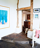 Labrador sits in flagstone timber framed doorway of Nottinghamshire barn conversion England UK