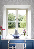 Jug and basin on bathroom windowsill of rural Oxfordshire cottage England UK