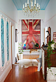 Union Jack and salvaged wall panels with chest of drawers in hallway of Warkworth home Auckland North Island New Zealand