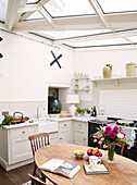 Recipe book open on wooden table in Bicester conservatory kitchen Oxfordshire England