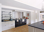 Stainless steel splashback above black range oven in spacious Buckinghamshire kitchen UK