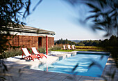 Pair of sunloungers on paved poolside in rural Brittany France