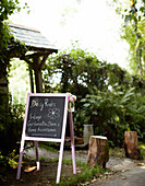 Chalkboard directing people to rural shop in Devonshire England UK