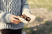 Man holding sausage sandwich at beach barbecue in County Sligo Connacht Ireland