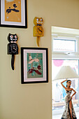 Framed artwork and novelty clocks with lamp figurine in County Durham home, North East England, UK