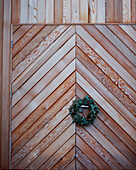 Floral wreath on exterior of wooden double doors in Worcestershire, England, UK