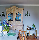 Upcycled dresser and service trolley in dining room of modernised Regency home, Cotswolds, England, UK