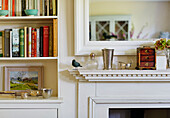 Silverware and books in Sandford St Martin cottage, Oxfordshire, UK