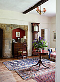 Wooden table and grandfather clock with original stone from Syresham church conversion, Northamptonshire, UK