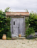 Wooden shed with terracotta pots in rural Oxfordshire, UK