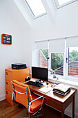 Orange chair and filing cabinet with desk at window in Durham home, England, UK
