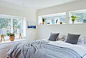 Double bed with lamps on sideboard in Bath home, Wiltshire, UK