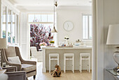 Breakfast bar and armchairs with view to balcony terrace in York home, UK